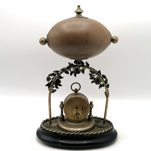 7 - Novelty emu egg mounted on a decorative nickel plated & wooden base stand sporting a clock to the ce... 