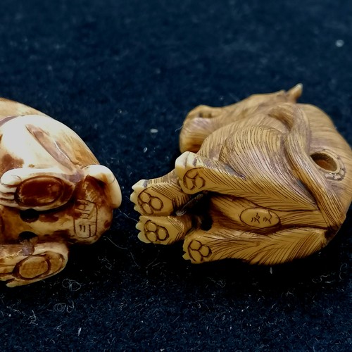 152 - 2 antique ivory signed Netsukes both of dogs, 1¾