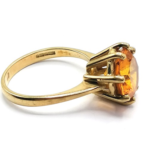 284 - 9ct gold & orange stone set ring - total weight 4.7g