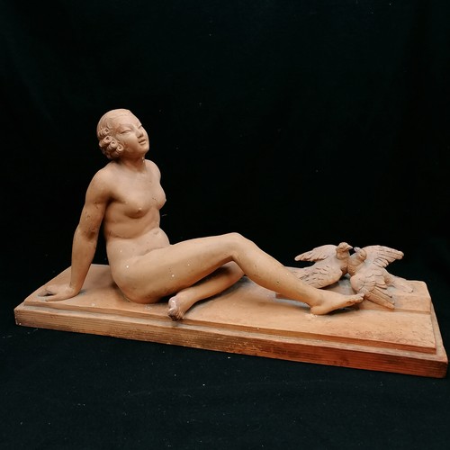 701 - Terracotta figure of a reclining lady signed J Montry, slight a/f broken wing on bird - 21