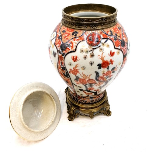 136 - Large oriental style pottery vase - brass mounted & the lid terminating with a foo dog - 16