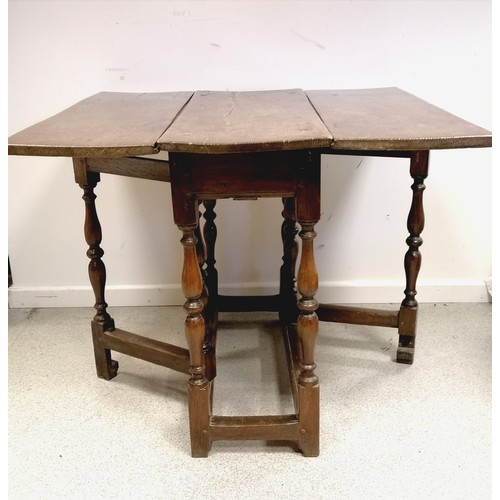 609 - Antique 18th century folk gateleg / drop flap table with turned baluster legs / supports with a cand... 