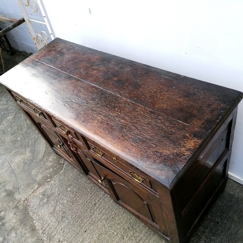 617 - 18th century oak low dresser comprising of 3 drawers over 2 cupboards with central panel - arched pa... 