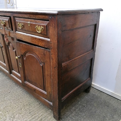 617 - 18th century oak low dresser comprising of 3 drawers over 2 cupboards with central panel - arched pa... 