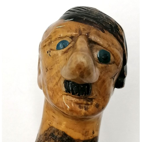 3 - Folk Art walking stick with a carved head handle of Hitler with painted eyes and hair. 94cm long