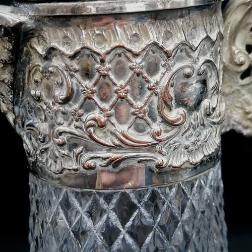 507 - Silver plated on copper claret jug with lion holding a shield finial - 33cm high