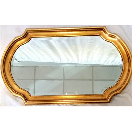 621 - Gilt framed shaped bevel edge mirror - 96cm x 55cm