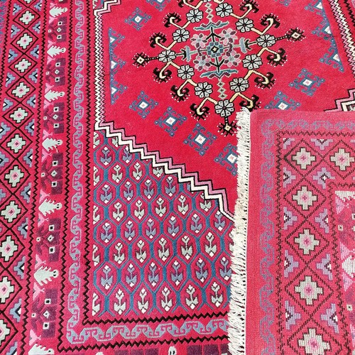 689 - Large red grounded good quality wool rug - 200cm x 285cm ~ in good condition