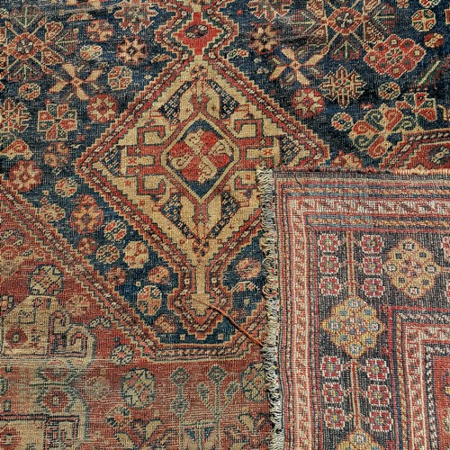 690 - Antique small red and blue grounded rug (a/f) - 190cm x 156cm. Has wear and 2 holes