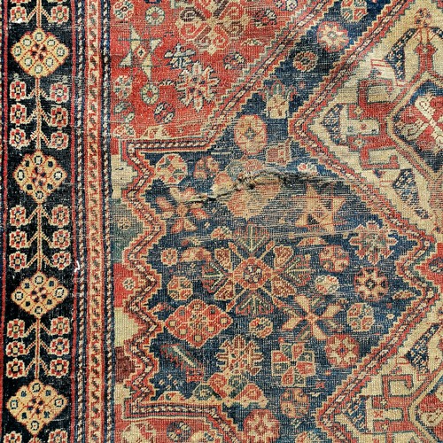 690 - Antique small red and blue grounded rug (a/f) - 190cm x 156cm. Has wear and 2 holes