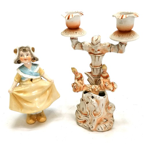 27 - Ceramic 'nodding'  candlestick 22cm high T/W a curtsying Dutch girl both in good condition