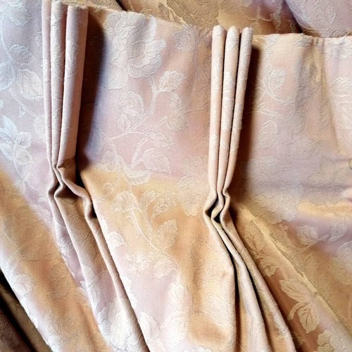 772 - Pair of pink curtains with embossed rose patttern. Each curtain 125cm wide x 217cm drop. With tie ba... 