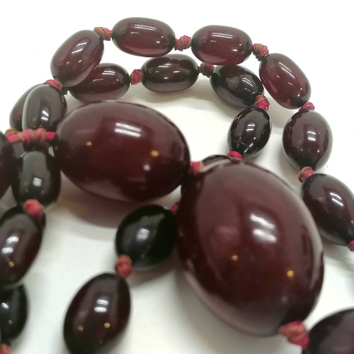 218 - Strand of cherry amber beads, 68cm length, 53g in weight (needs restringing)  - SOLD ON BEHALF OF TH... 