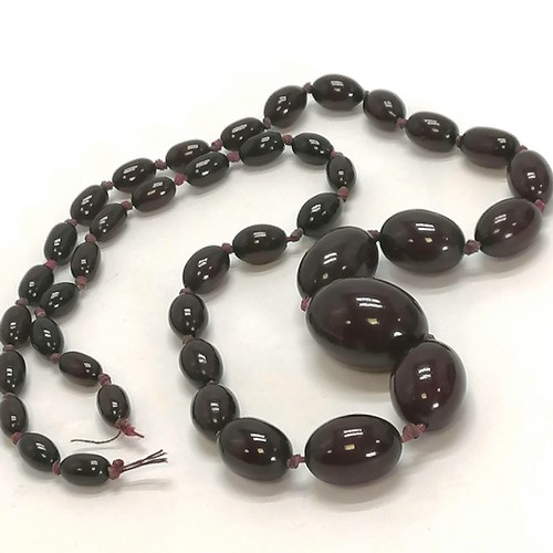 218 - Strand of cherry amber beads, 68cm length, 53g in weight (needs restringing)  - SOLD ON BEHALF OF TH... 