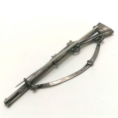 219 - Antique unmarked silver brooch in the form of a flint lock rifle, 9.5cm length, weight 7.7g  - SOLD ... 