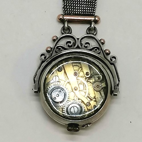 307 - Antique unmarked silver swivel watch with domed crystal to front and back on an unmarked silver and ... 