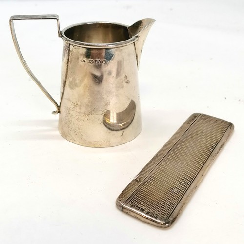 364 - Silver cream jug, height 7cm (one small dent to the body), t/w silver cased comb total weight 81.5g