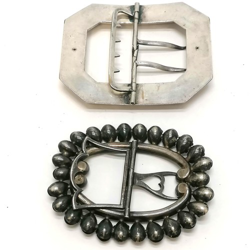 369 - Silver and paste buckle 8cm across, 1 red stone missing, t/w a plated buckle