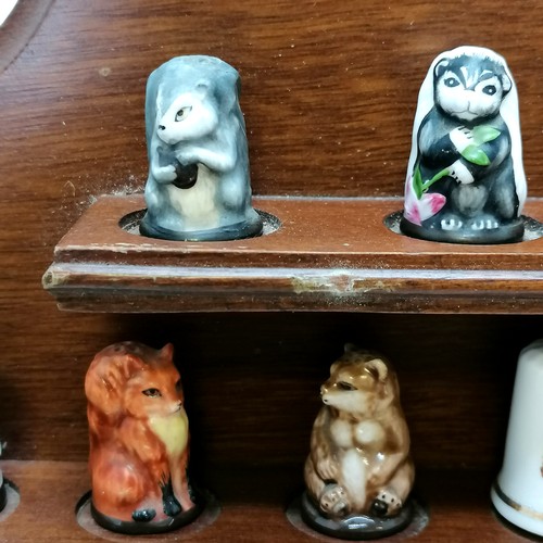 447 - Collection of novelty mostly china animal thimbles T/W a collectors shelf