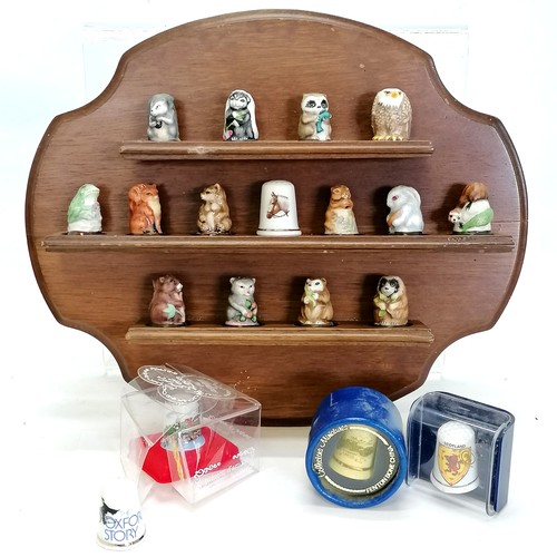 447 - Collection of novelty mostly china animal thimbles T/W a collectors shelf