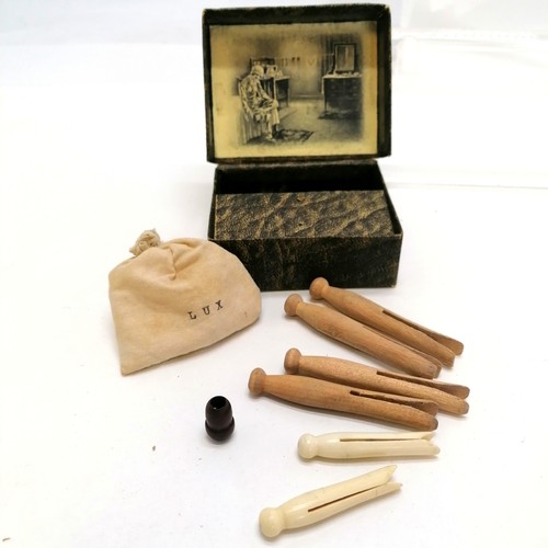 455 - Antique travel set with small bag of Lux soap, 2 carved bone pegs (4cm) & 4 wood pegs t/w 1899 book ... 