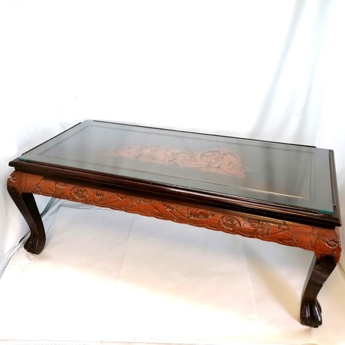 538 - Vintage Oriental carved camphor wood coffee table with glass top. 102cm x 48cm x 40cm high. In overa... 