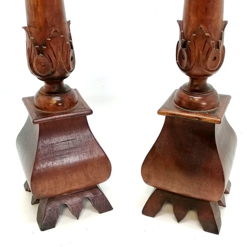 557 - Pair of carved teak pricket candlesticks - 65cm high & in good condition