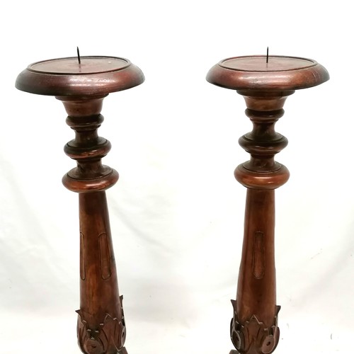 557 - Pair of carved teak pricket candlesticks - 65cm high & in good condition