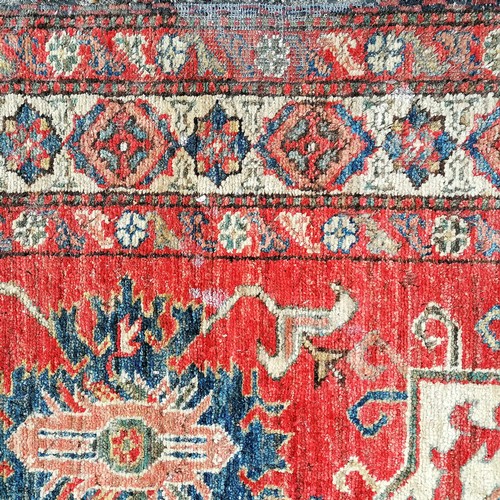 562 - Pair of Persian red grounded wool rugs - 184cm x 106cm & both with some damage