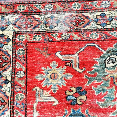 562 - Pair of Persian red grounded wool rugs - 184cm x 106cm & both with some damage