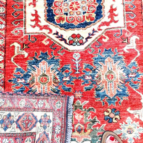 562 - Pair of Persian red grounded wool rugs - 184cm x 106cm & both with some damage