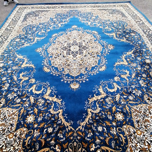 597 - Large blue ground Wilton carpet 12' x 15'. In good used condition