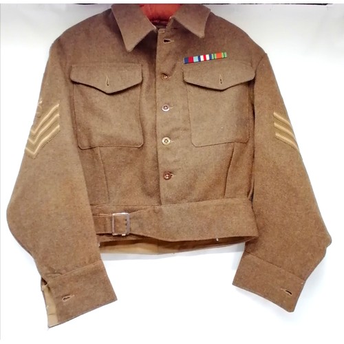 600 - R.E.M.E 2nd WW size 9 uniform jacket with insignia cloth badges. In good condition