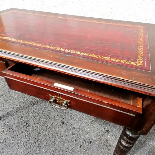 612 - Edwardian leather topped mahogany writing table with 2 drawers and on brass casters - 106cm x 60cm x... 