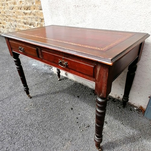 612 - Edwardian leather topped mahogany writing table with 2 drawers and on brass casters - 106cm x 60cm x... 