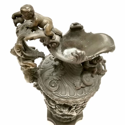 20A - Antique bronze ewer in the style of Benvenuto Cellini profusely decorated with putti at play on a th... 