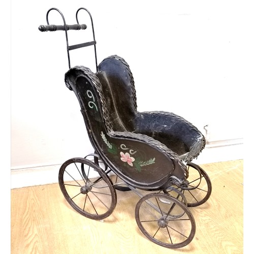 30 - Antique dolls pram with wooden body and rexine lining and hood (af). Later cotton cushions, T/W vint... 
