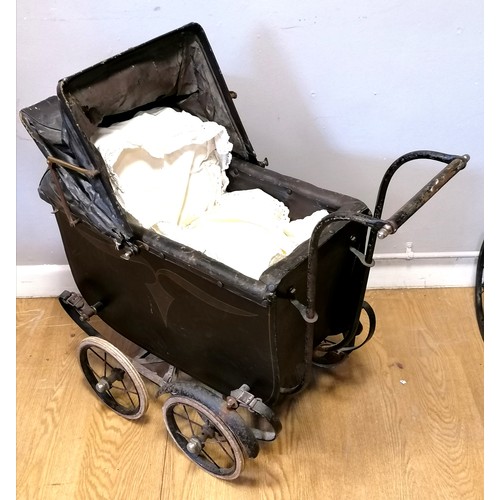 30 - Antique dolls pram with wooden body and rexine lining and hood (af). Later cotton cushions, T/W vint... 