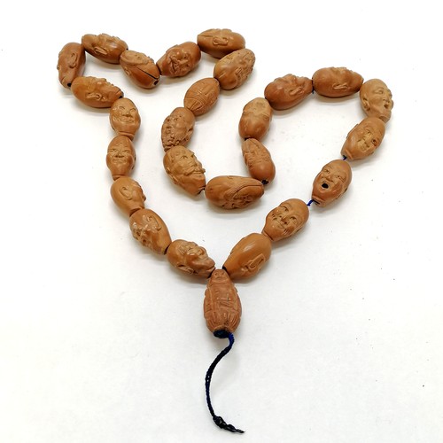 474 - Strand of 26 hand carved wooden beads mostly depicting facial expressions - approx length of bead 2.... 