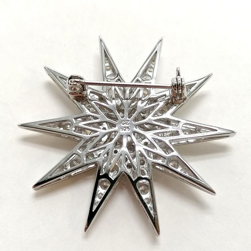 299 - Silver star brooch set with CZ - 4.2cm across & 11g