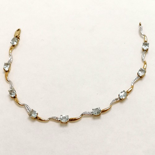 309 - 9ct marked gold bracelet set with 9 blue topaz stones & 2 diamonds - 18cm long & 3.6g total weight