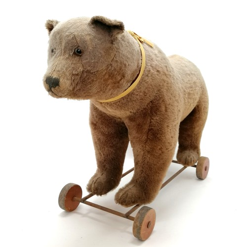 2 - Antique Steiff brown bear on metal framed wooden wheels and small black button to ear & working grow... 