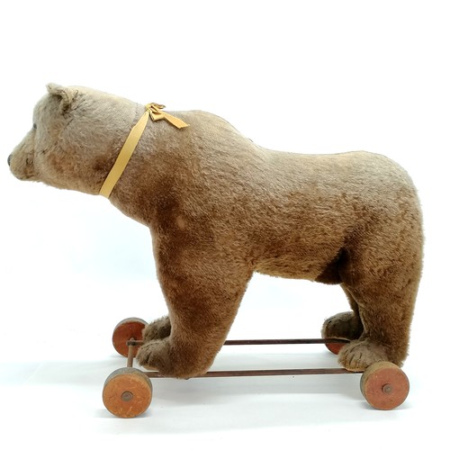 2 - Antique Steiff brown bear on metal framed wooden wheels and small black button to ear & working grow... 