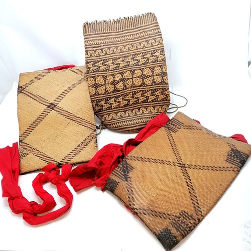 192 - Three tribal/Nepalese rattan back packs/bags tallest 47cm high, two have red cotton straps in good u... 