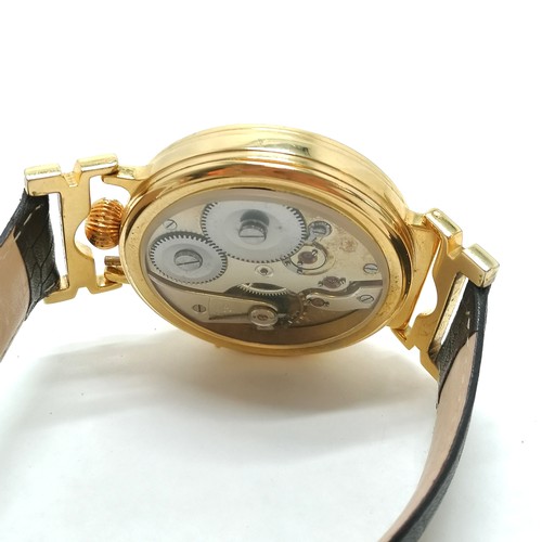 234 - Large pocket watch movement converted to a wristwatch (gold plated case diameter 5cm) with mechanica... 