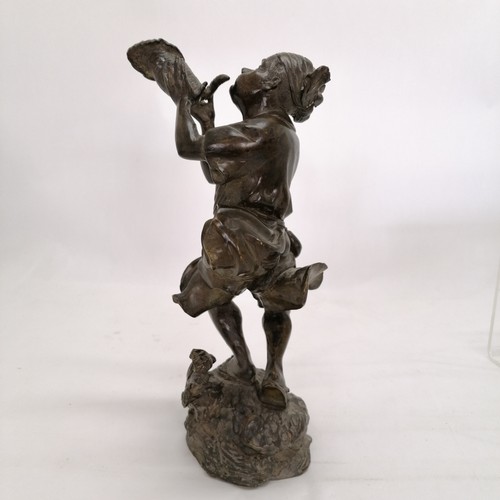 86 - Oriental bronze sculpture of a man with a conch shell with rock and wave detail to base. 29cm high