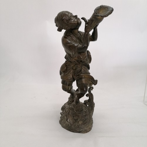 86 - Oriental bronze sculpture of a man with a conch shell with rock and wave detail to base. 29cm high