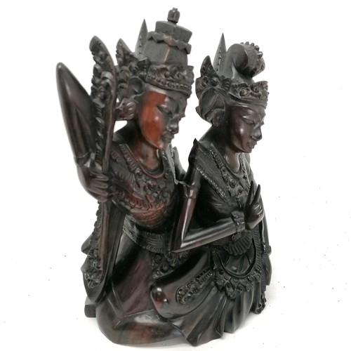 94 - An Asian hardwood carving of 2 deity seated figures  25cm high T/W a smaller carved guardian figure