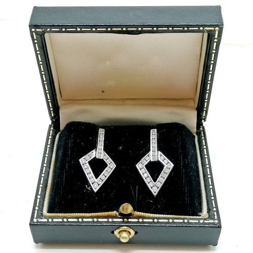 102 - 18ct hallmarked white gold diamond channel set earrings with 18ct gold heart shaped backs in origina... 