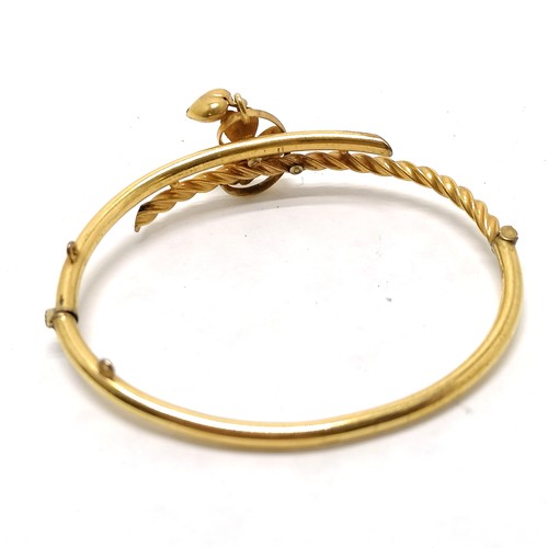 111 - Antique gilt metal bangle with 3 leaf clover / heart detail set with a pearl -  - SOLD ON BEHALF OF ... 